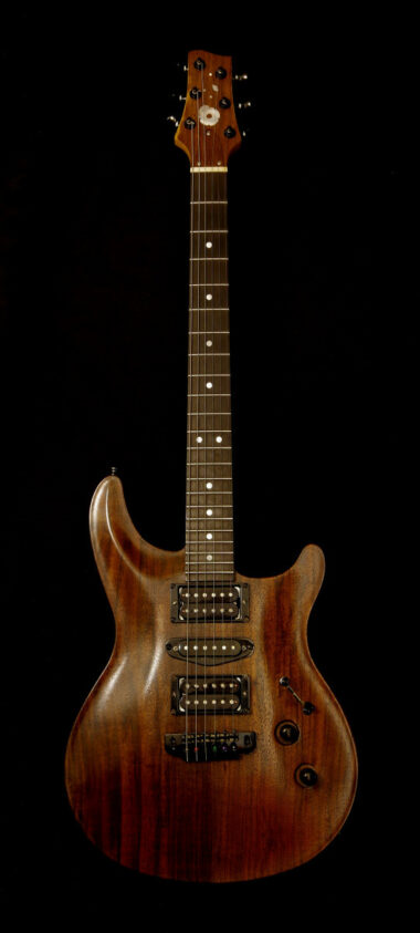 The Serial Number 1 guitar, in dark walnut with black hardware