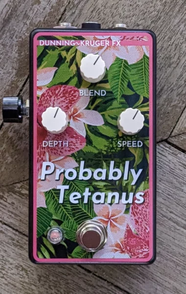 The Probably Tetanus pedal, decorated with a closeup painting of flowers, zoomed to the point where the texture of the paint is visible
